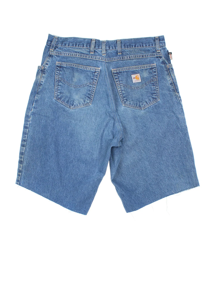 Carhartt Cut Off Shorts in blue colourway. Zip fly fastening with multiple pockets, frayed hem and embroidered branding on the back.
