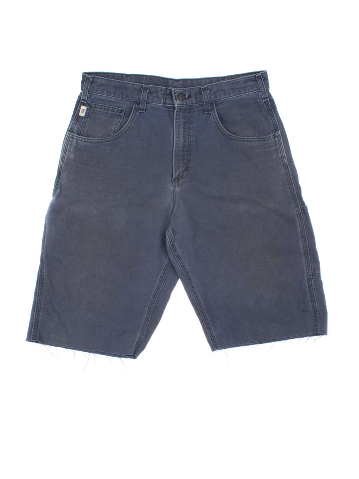 Carhartt Cut Off Shorts in blue colourway. Zip fly fastening with multiple pockets, frayed hem and embroidered branding on the back.