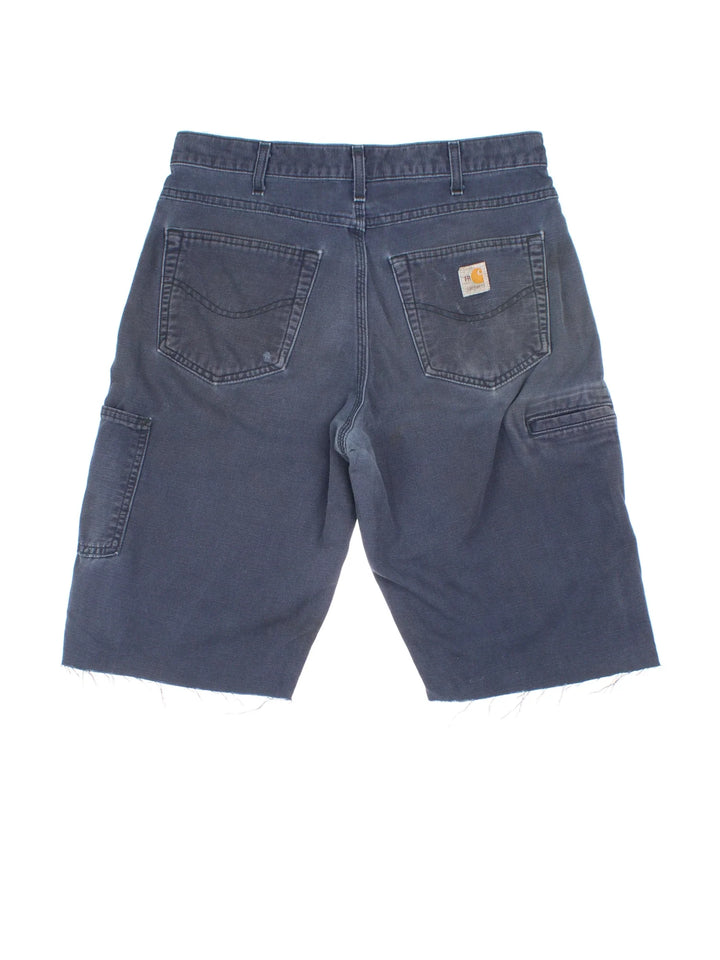 Carhartt Cut Off Shorts in blue colourway. Zip fly fastening with multiple pockets, frayed hem and embroidered branding on the back.