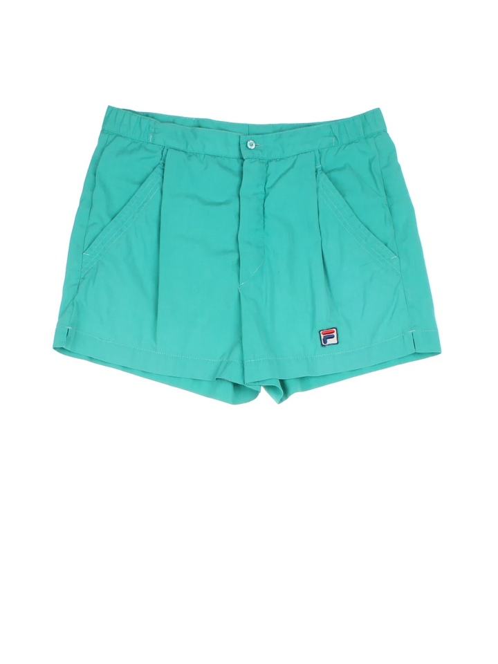 Vintage Fila Tennis Shorts in blue colourway with pockets, pleated and the logo embroidered on the front.