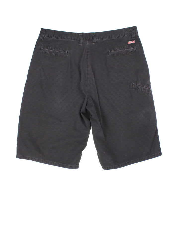 Vintage Dickies shorts in black colourway with multiple pockets and the logo embroidered on the back.