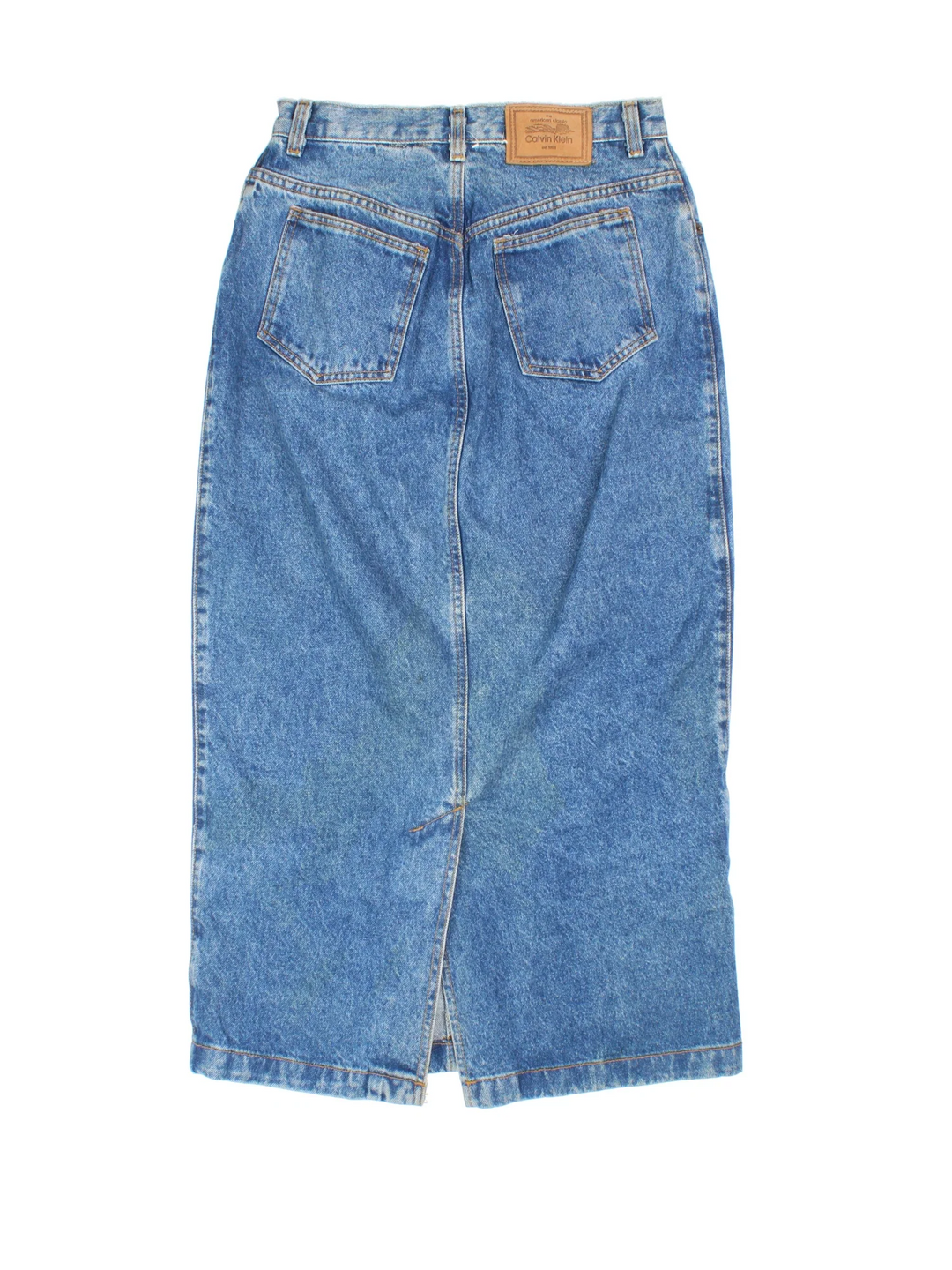 90's Calvin Klein Denim Maxi Skirt in blue colourway. Front zip fastening, with side pockets and leather patch branding.