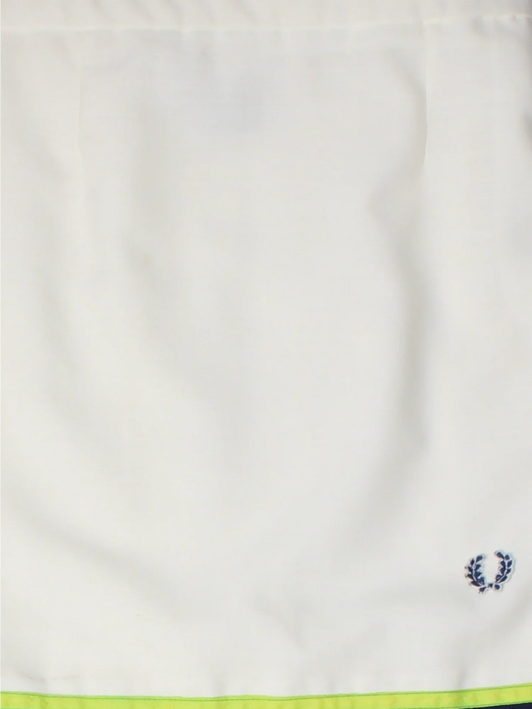 Fred Perry Tennis Skirt in white colourway. Wrap around fastening, full circle pleated skirt with embroidered branding on the front.