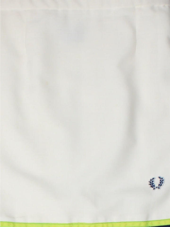 Fred Perry Tennis Skirt in white colourway. Wrap around fastening, full circle pleated skirt with embroidered branding on the front.