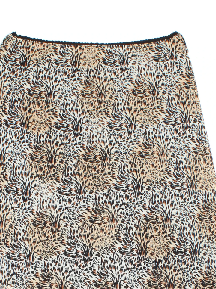Y2K Leopard Print Asymmetrical Skirt in tan colourway with all over print and sheer overlay.