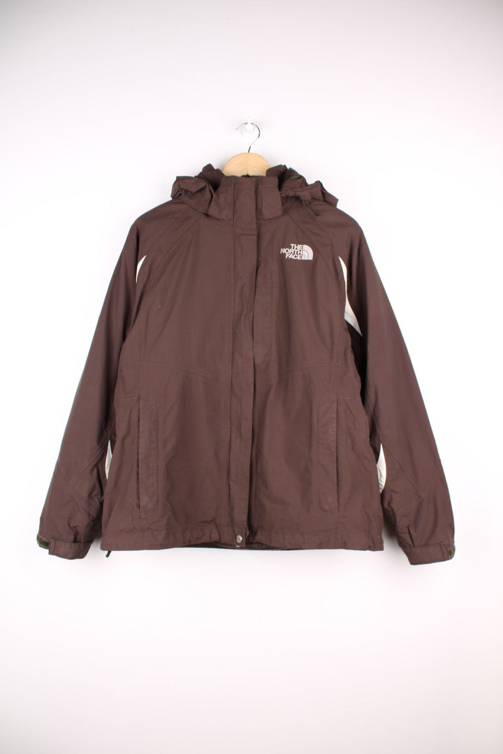 The North Face Hyvent Jacket in brown. The jacket has a removable fleece lining, multiple pockets, and a removable hood.