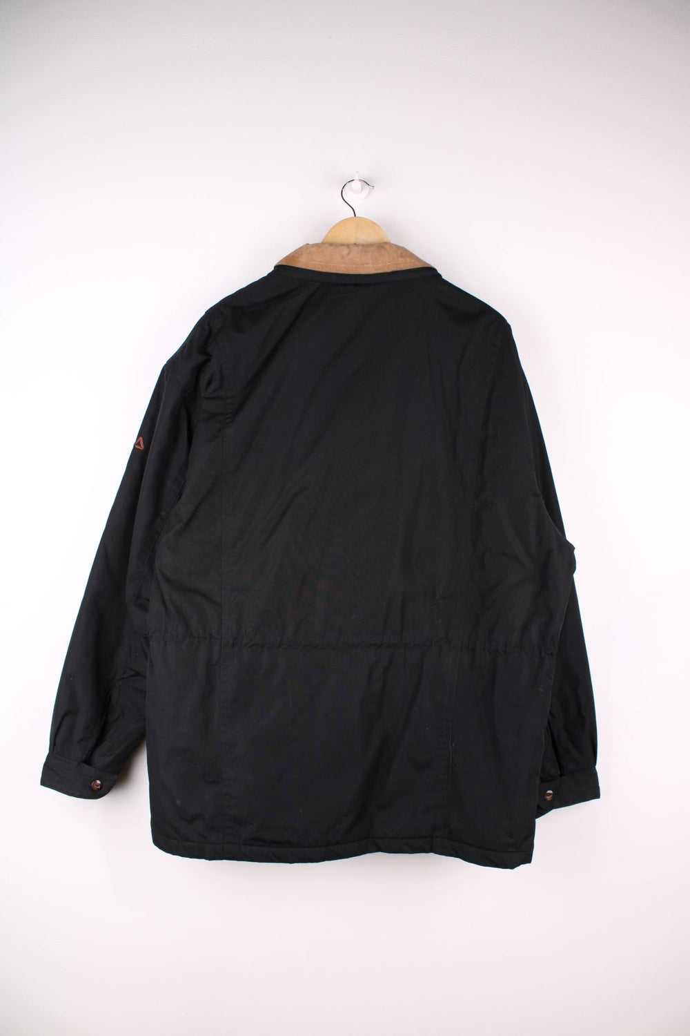 Vintage 90s Fila Sport Coat in black. The coat has a double layered collar, one is suede. There are also two large pockets with button closures, and the coat closes with a zip and wooden toggle buttons. 