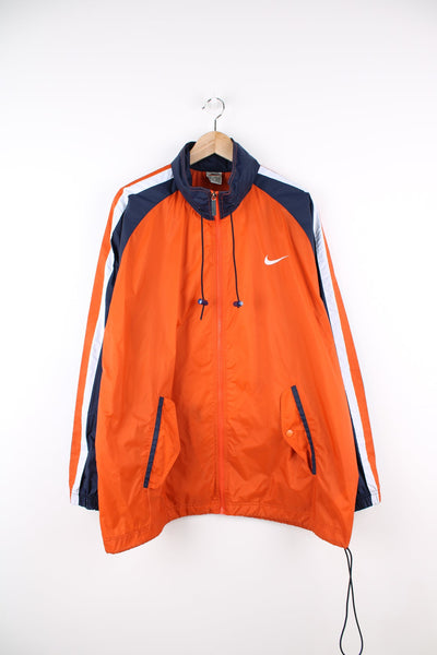 Vintage Nike lightweight windbreaker jacket in orange, blue and white. Features embroidered logo on the chest, printed logo on the back and a pack away hood.