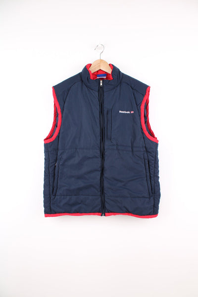Reebok Classic blue and red gilet featuring embroidered logo on the chest and printed logo across the back.