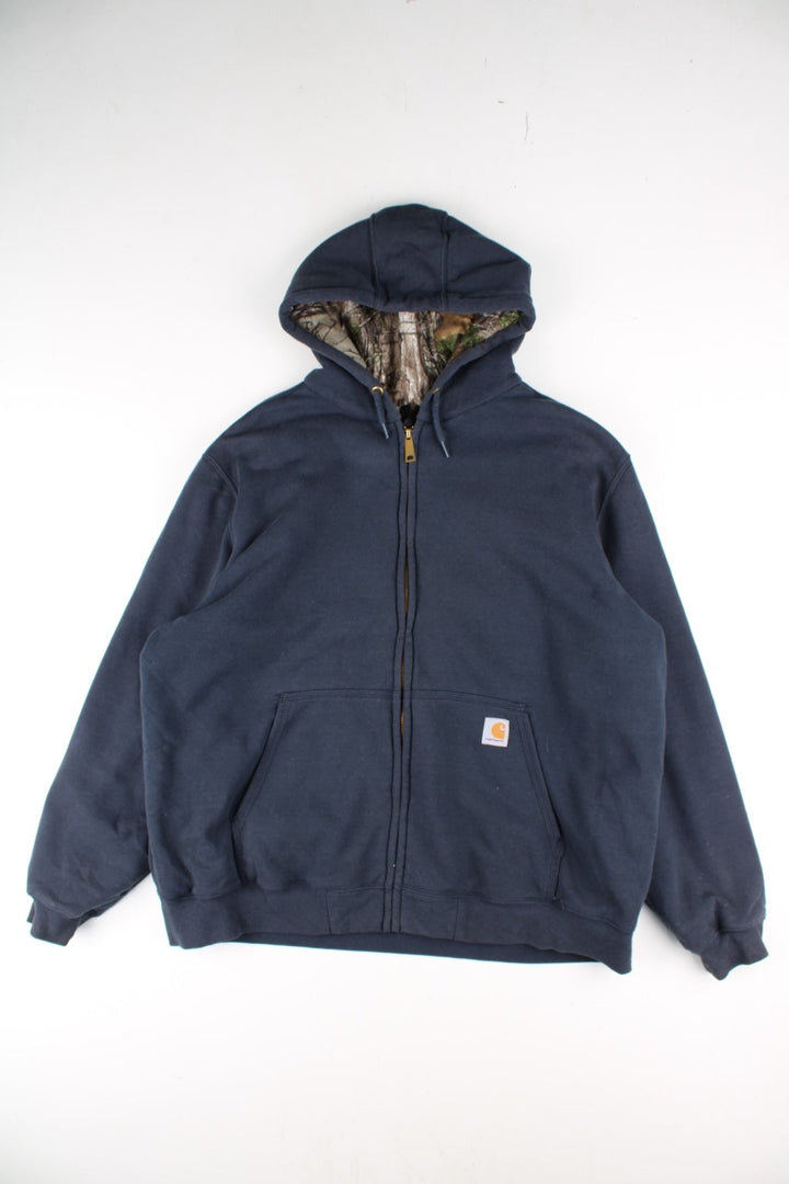 Carhartt Hoodie in a blue colourway with camo print lining. Large pocket and small classic logo on the front. 