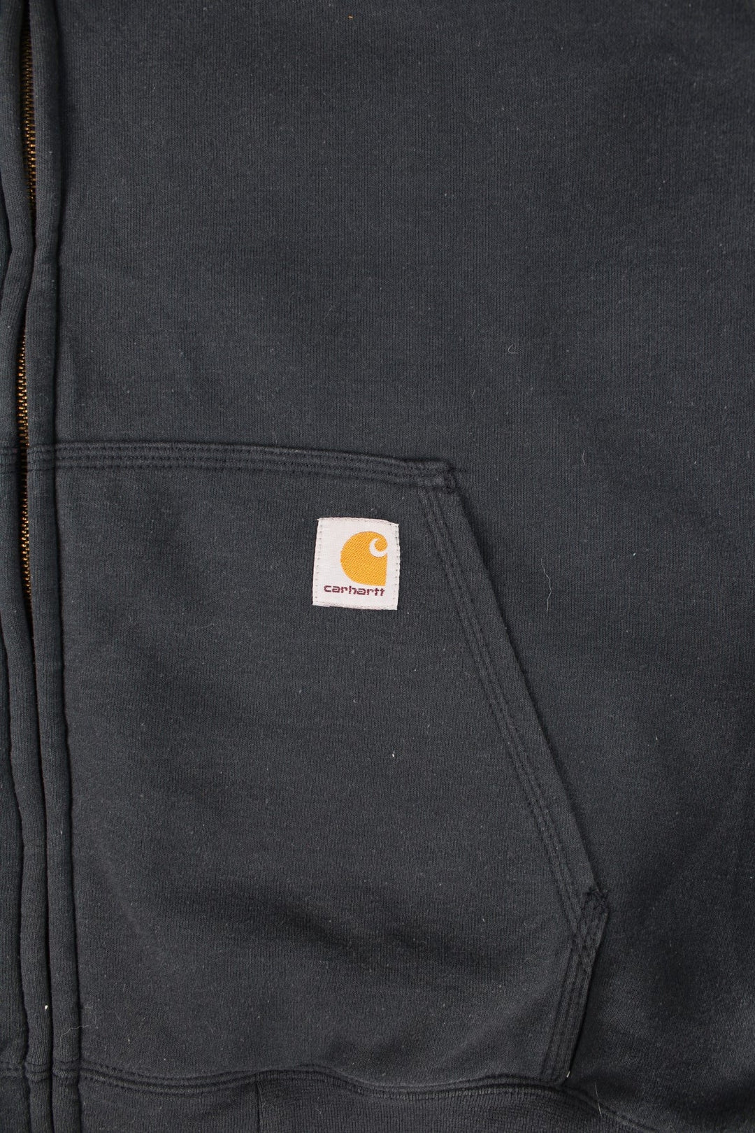 Carhartt Hoodie in a blue colourway with camo print lining. Large pocket and small classic logo on the front. 