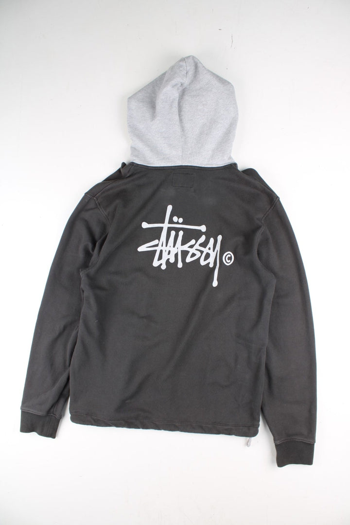 Stussy Two Tone Sweatshirt in a grey colourway with pocket and small logo on the front. Large Stussy logo on the back.
