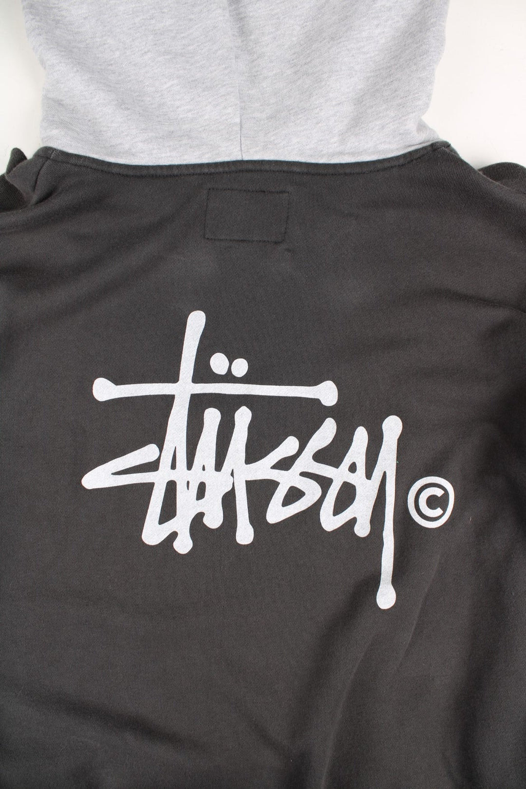 Stussy Two Tone Sweatshirt in a grey colourway with pocket and small logo on the front. Large Stussy logo on the back.