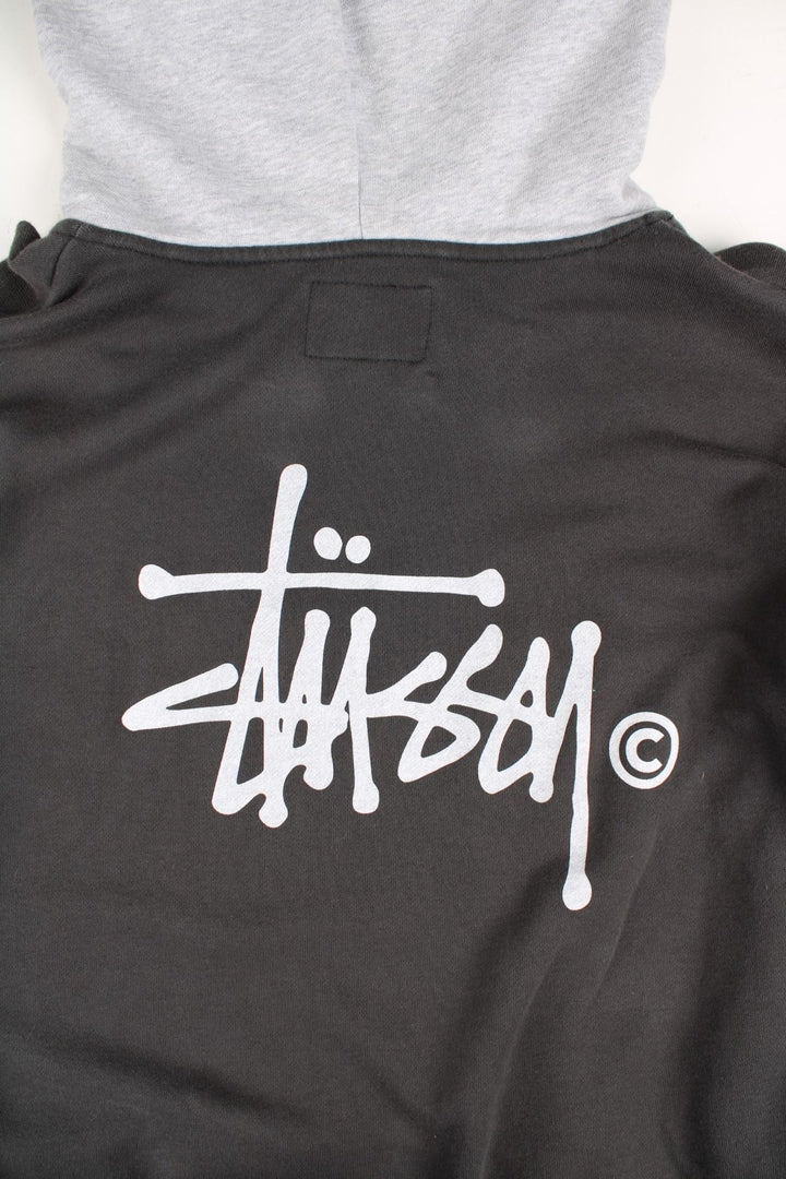 Stussy Two Tone Sweatshirt in a grey colourway with pocket and small logo on the front. Large Stussy logo on the back.