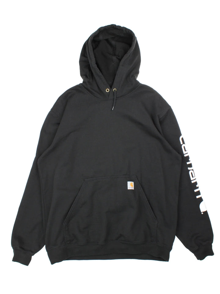 Carhartt Pullover Hoodie in a black colourway with large pocket and small classic logo on the front, and printed spell out on the left sleeve.