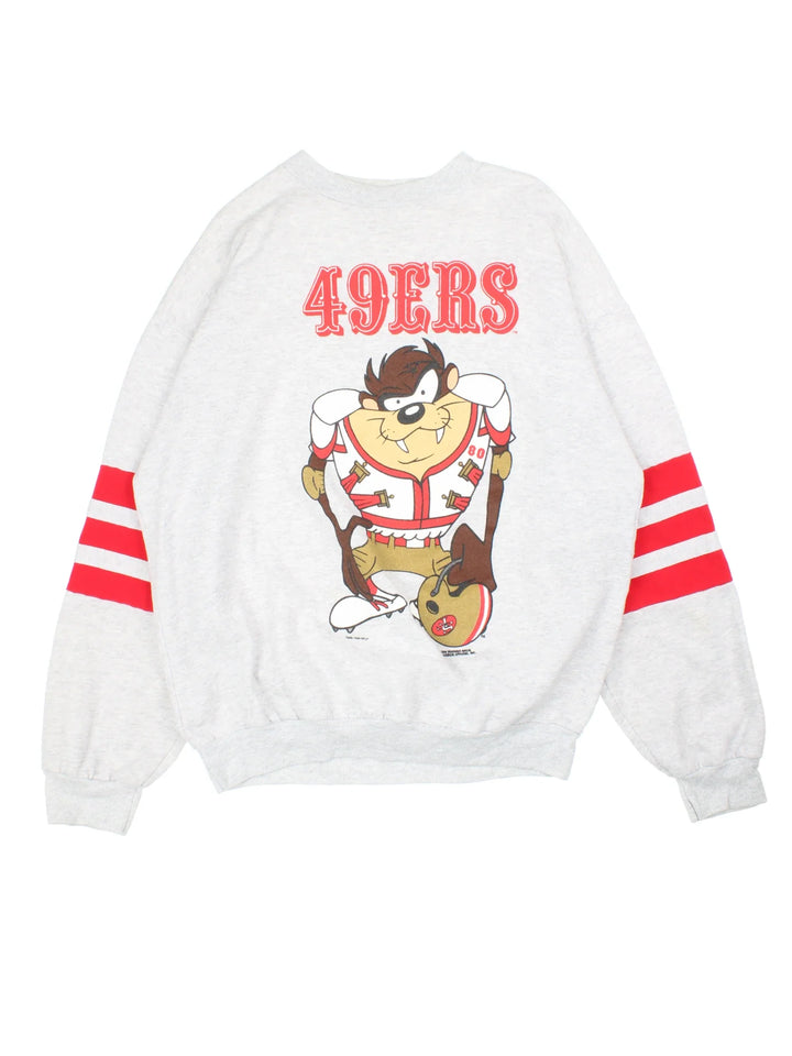 Vintage 90's San Francisco 49ers Taz Looney Tunes Sweatshirt in a grey colourway with red stripe detailing on the sleeves and large looney toon Taz graphic on the front.