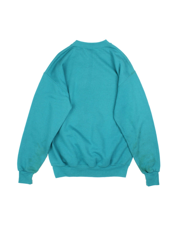 Vintage 1993 Miami Dolphins NFL Nutmeg Sweatshirt in a blue colourway with graphic print and team spell out on the front.