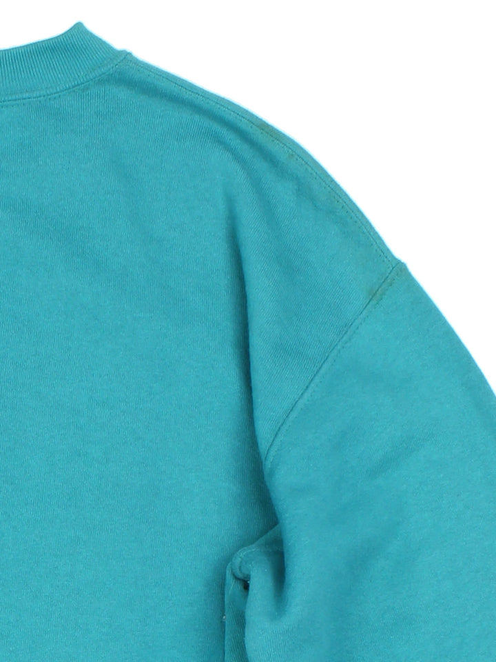Vintage 1993 Miami Dolphins NFL Nutmeg Sweatshirt in a blue colourway with graphic print and team spell out on the front.
