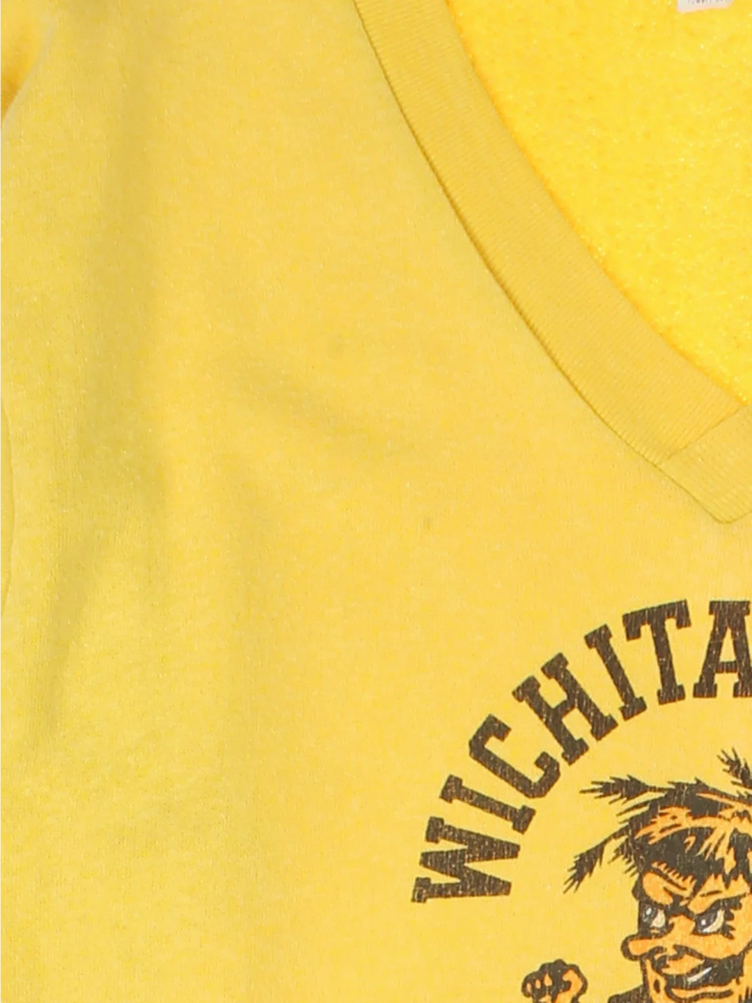 Vintage 60's Wichita State University Sweatshirt in a yellow colourway, v neck collar with the logo and graphic printed on the front.