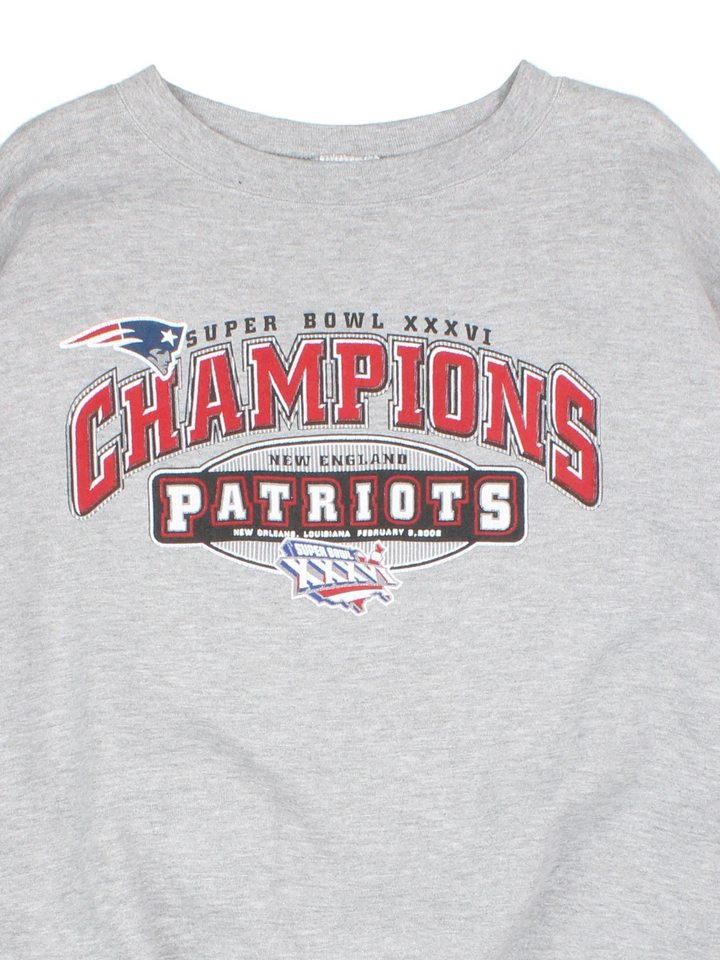 2002 New England Patriots NFL Champions Sweatshirt in a grey colourway, with graphic and spell out printed on the front.