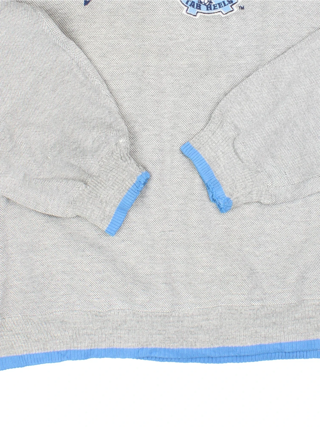 Vintage North Carolina Tar Heels Basketball Sweatshirt in a grey colourway, with contrast hems/cuffs and branding embroidered on front.