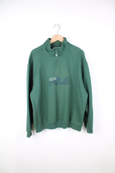 90's Fila all green 1/4 zip sweatshirt, features embroidered spell-out logo across the chest and on the cuff