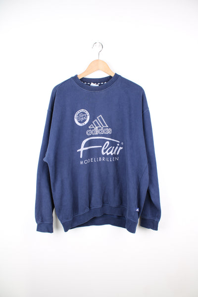 Vintage Gutersloh in Germany x Adidas crewneck sweatshirt in blue. Features embroidered spell-out logo across the chest and raised sponsor