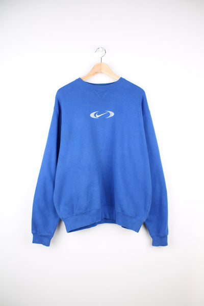 Vintage Nike crew neck sweatshirt in blue. Features embroidered bracket swoosh logo.