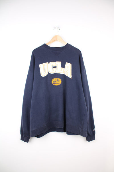 Vintage Ucla sweatshirt in navy blue by Adidas. Features embroidered logo across the chest.