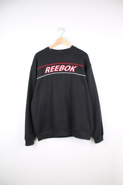 Black Reebok sweatshirt with red and white embroidered logo across the chest.