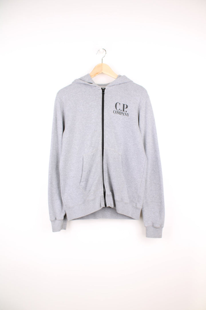 CP Company grey zip through hoodie with goggles and printed logo on the chest.