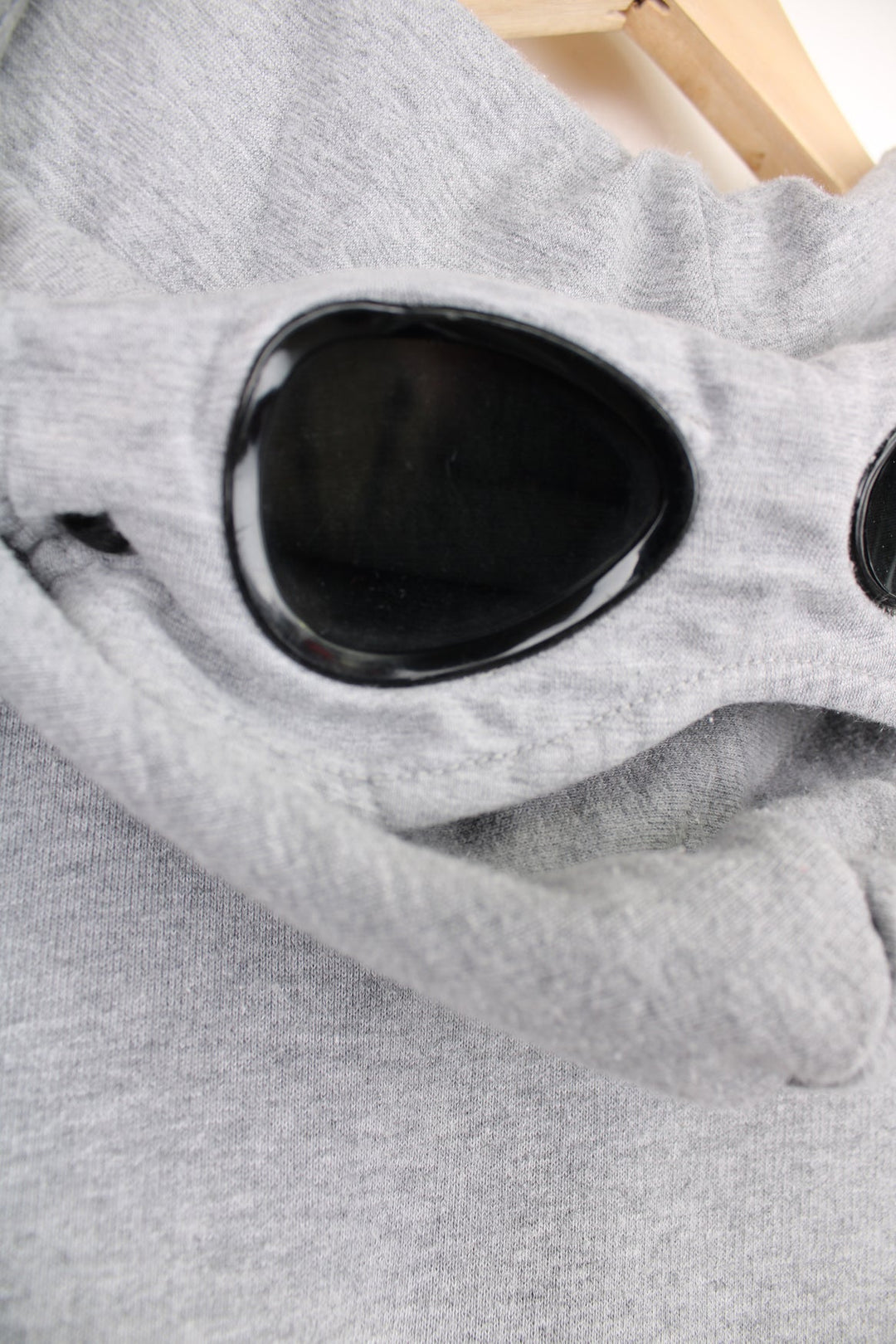 CP Company grey zip through hoodie with goggles and printed logo on the chest.