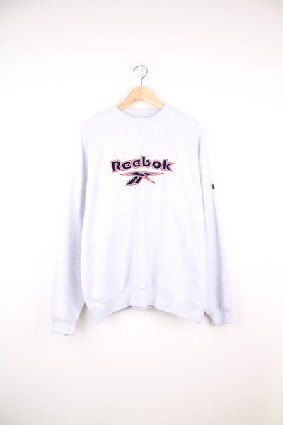 Grey Reebok sweatshirt with red and blue embroidered logo across the chest. 
