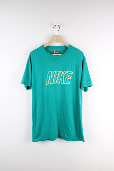 90s Nike turquoise single stitch t-shirt, features printed spell-out logo across the chest