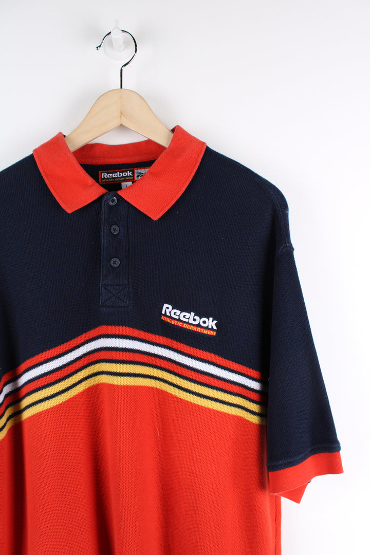 Reebok Athletic Department red and blue polo shirt with embroidered logo on the chest 