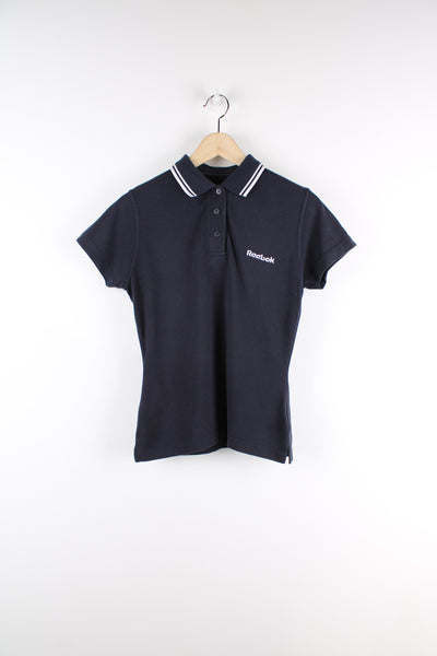 Vintage Reebok navy blue polo shirt, features embroidered Reebok logo on the chest