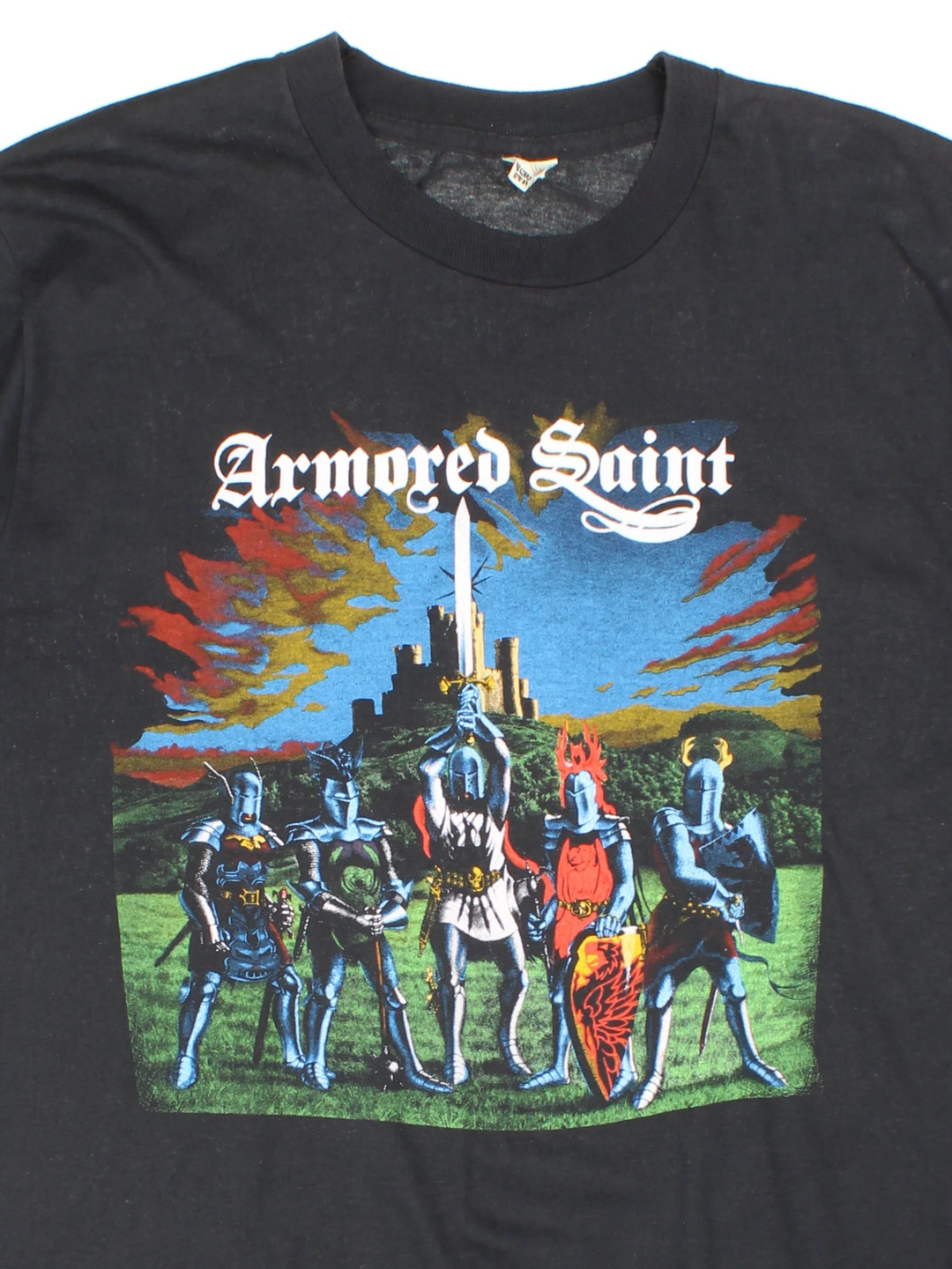 Vintage 80's Armored Saint March Of The Saint single stitch T-Shirt in a black colourway with a medieval knights graphic printed on the front, and the bands pictured and spell out printed on the back.