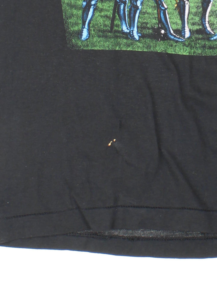 Vintage 80's Armored Saint March Of The Saint single stitch T-Shirt in a black colourway with a medieval knights graphic printed on the front, and the bands pictured and spell out printed on the back.
