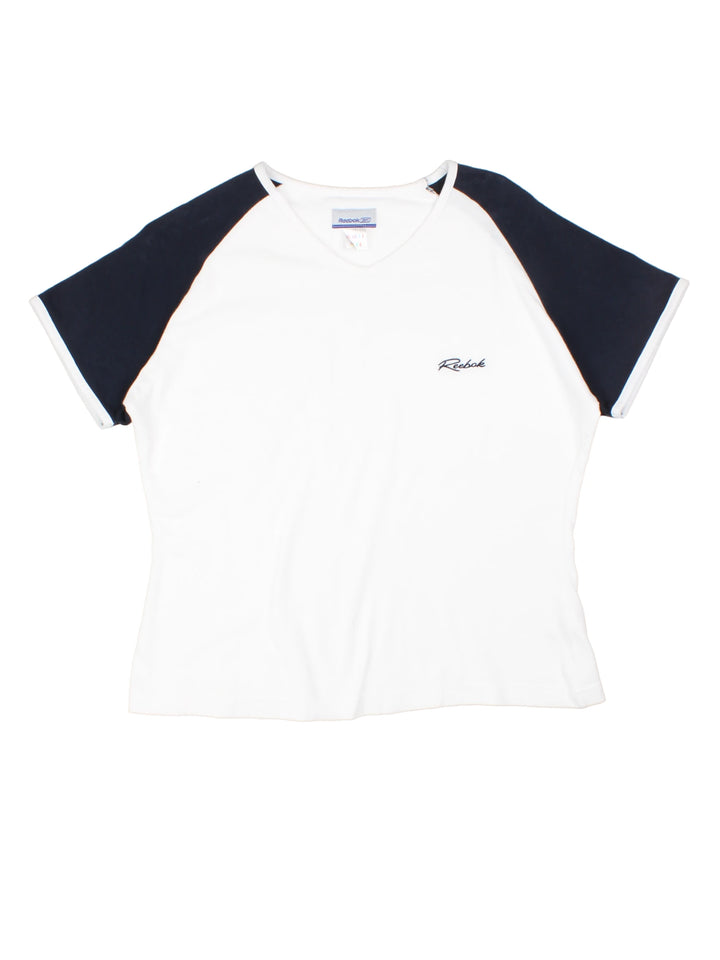 2000's Reebok white and blue v-neck baby tee, features white piping and embroidered spell-out logo on the chest