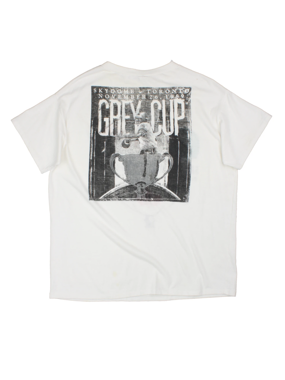 Vintage 1989 CFL Grey Cup Saskatchewan Roughriders vs Hamilton Tiger Cats tee in white with helmet face-off graphic on the front and photo of trophy on the back.