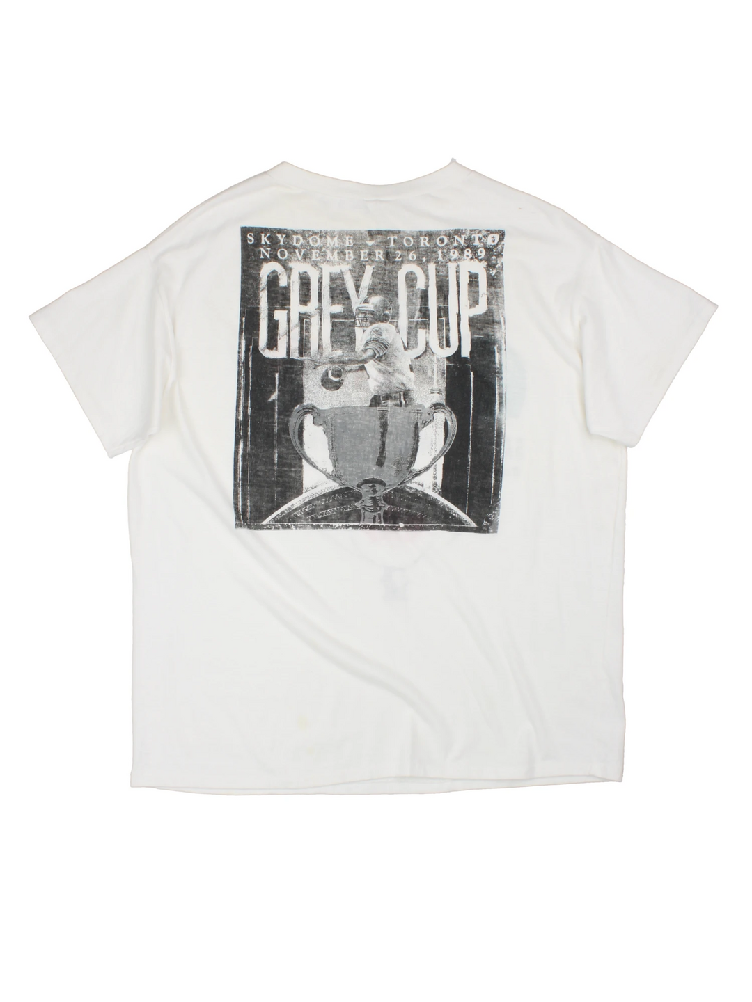 Vintage 1989 CFL Grey Cup Saskatchewan Roughriders vs Hamilton Tiger Cats tee in white with helmet face-off graphic on the front and photo of trophy on the back.
