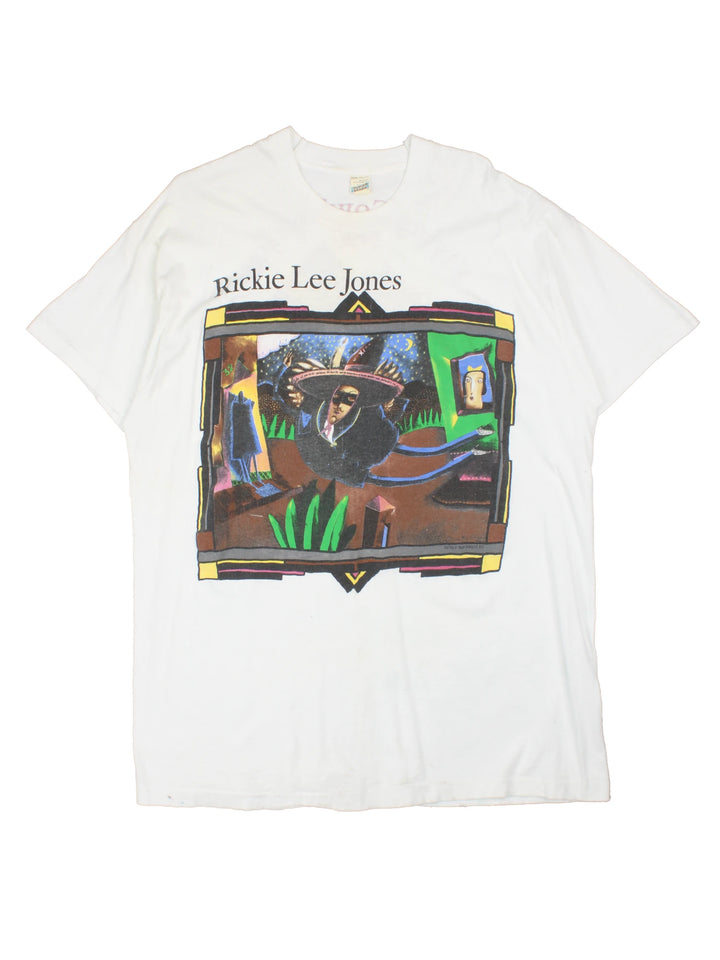 Vintage 1990 Rickie Lee Jones Flying Cowboys Tour T-Shirt in a white colourway, single stitch, and has large art graphic and spell out printed on the front, and on the back has the tour dates and spell out.