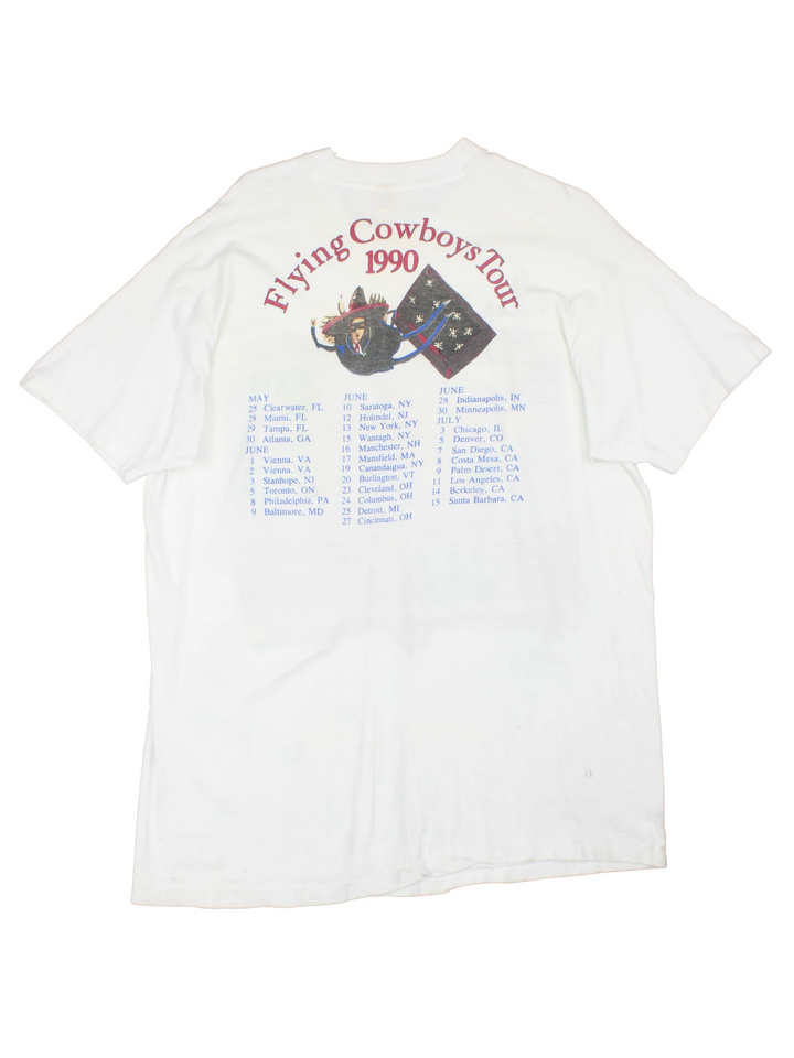 Vintage 1990 Rickie Lee Jones Flying Cowboys Tour T-Shirt in a white colourway, single stitch, and has large art graphic and spell out printed on the front, and on the back has the tour dates and spell out.