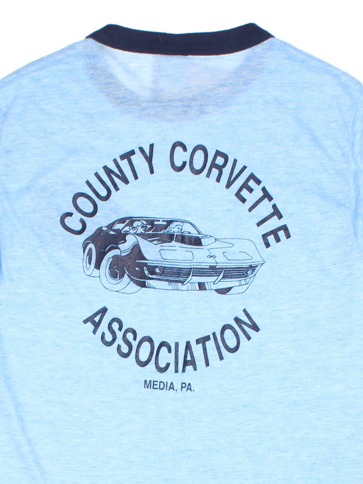 Vintage County Corvette Ringer T-Shirt in a blue colourway with the logo badges embroidered on the front and big graphic print on the back.