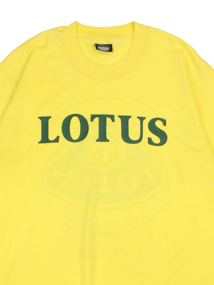 Vintage 90's Lotus Car Logo T-Shirt in a yellow colourway with the spell out printed on the front and graphic the back.