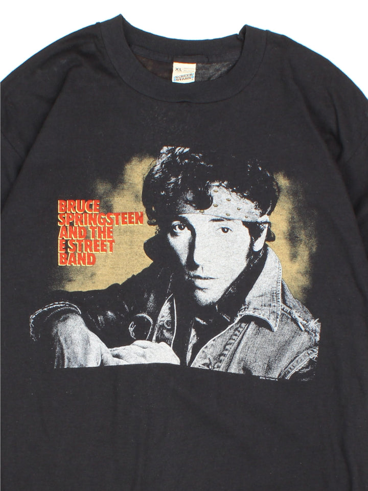 Vintage 1985 Bruce Springsteen World Tour T-Shirt in a black colourway with photo graphic printed on the front and band spell out and graphic on the back.