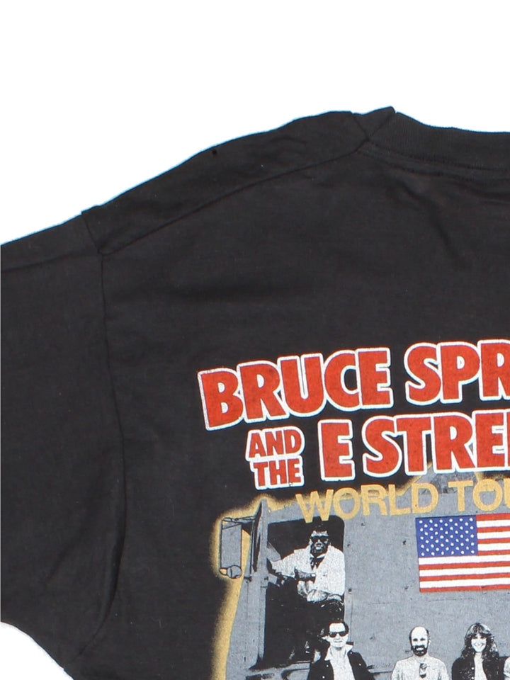 Vintage 1985 Bruce Springsteen World Tour T-Shirt in a black colourway with photo graphic printed on the front and band spell out and graphic on the back.