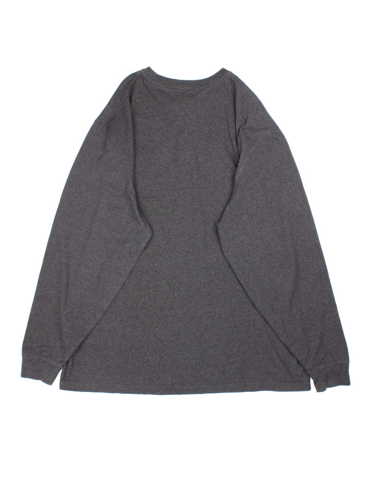 Carhartt Long Sleeve T-Shirt in a grey colourway. Button up with pocket on the front and small classic logo. 