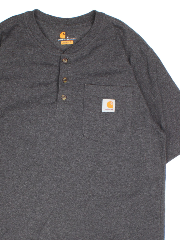 Carhartt T-Shirt in a grey colourway. Button up with pocket on the front and small classic logo..