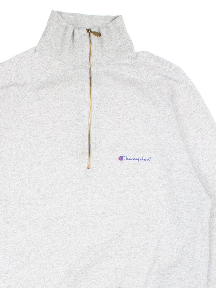 Vintage Champion 1/4 Zip Lightweight Sweatshirt in a grey colourway with the logo embroidered on the front.